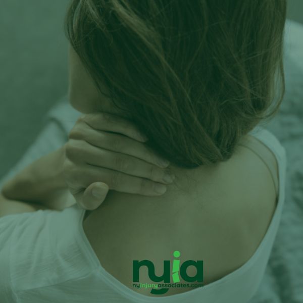 A person sits on a bed and holds their neck with one hand, suggesting discomfort. The "njia" logo is visible at the bottom of the image.