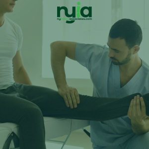 A No-Fault Doctor in Brentwood examines a patient's leg while the patient sits on an exam table. The NYIA logo is visible at the top of the image.