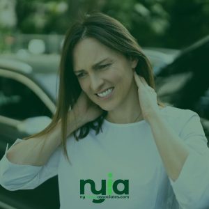 Woman standing outdoors by a car, holding her neck and appearing to be in discomfort—consider consulting an auto accident doctor in Freeport; nuiaassociates.com logo at the bottom.