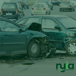 Two cars with significant front-end and side damage after a collision on a busy street; other vehicles are visible in the background, highlighting the need for no fault doctors in Freeport.